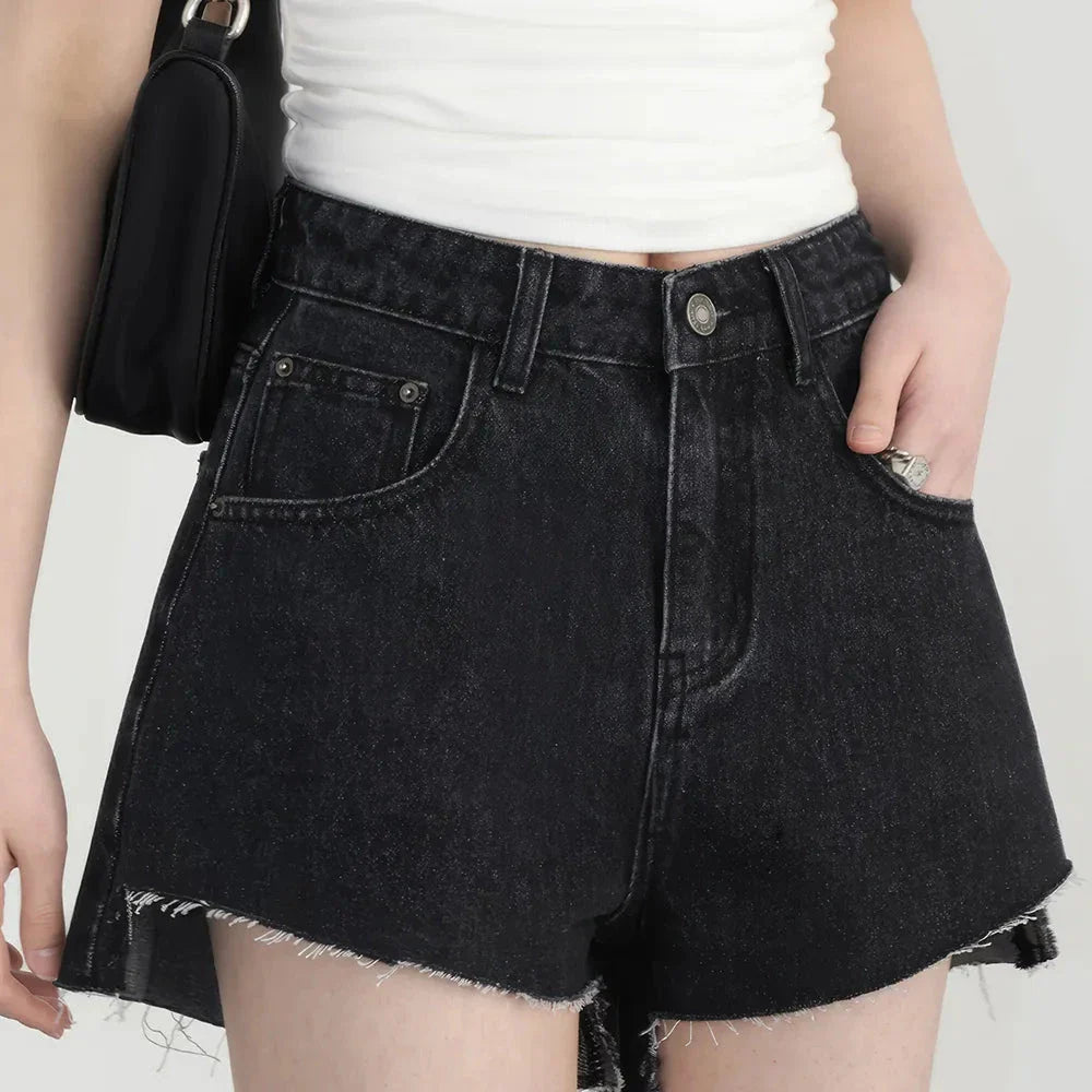 Women's high-waisted denim shorts with asymmetric hemline in black colour