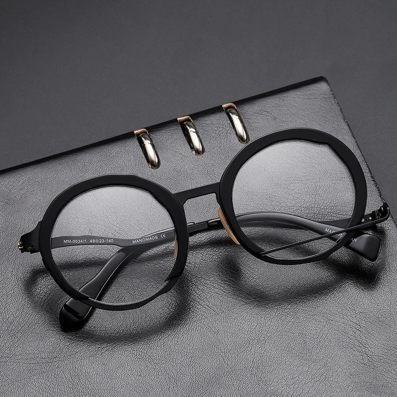 A close-up view of a premium fashion metal spectacle frame in black, white gold, and black gold colours.