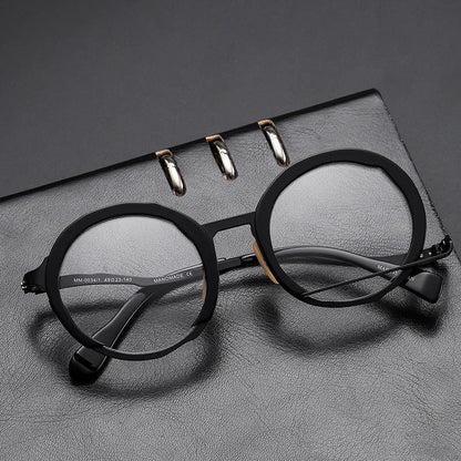 A close-up view of a premium fashion metal spectacle frame in black, white gold, and black gold colours.