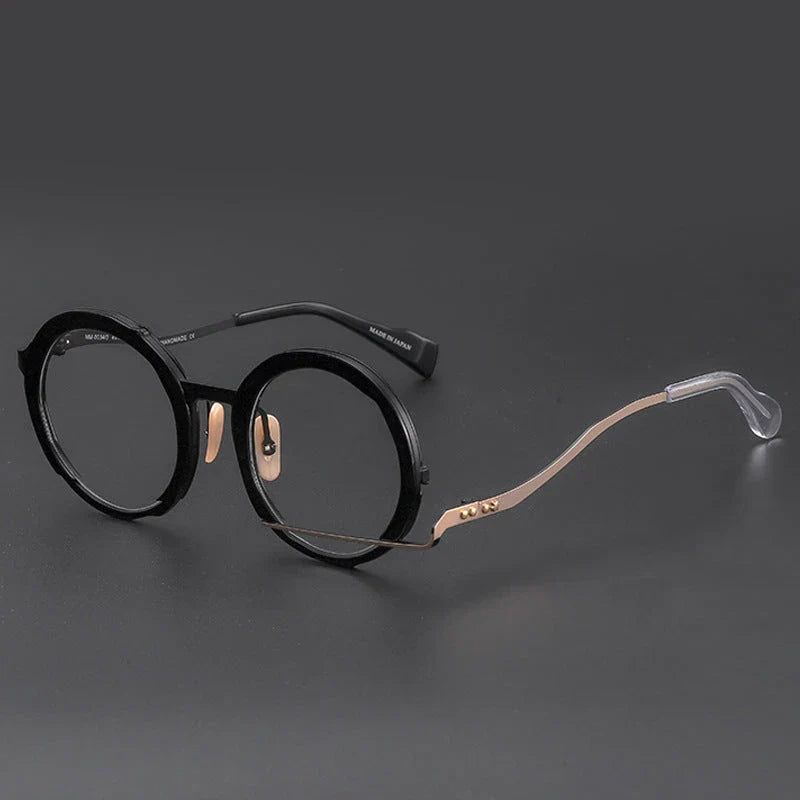 A close-up view of a premium fashion metal spectacle frame in black, white gold, and black gold colours.