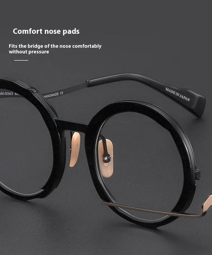 A close-up view of a premium fashion metal spectacle frame in black, white gold, and black gold colours.