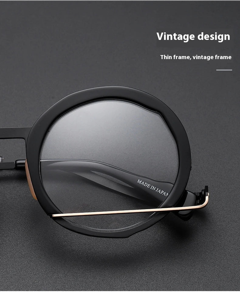 A close-up view of a premium fashion metal spectacle frame in black, white gold, and black gold colours.