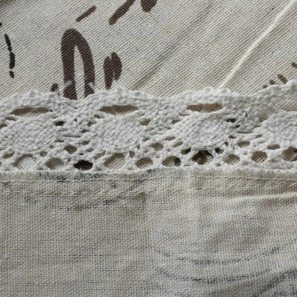 A decorative Paris-themed cotton and linen tablecloth featuring iconic landmarks and a romantic French design