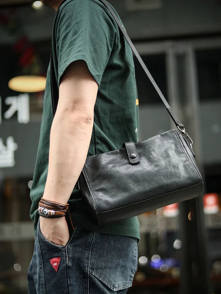 Cowhide one shoulder diagonal fashion bag in black, featuring an adjustable strap and premium leather construction for stylish and practical everyday use.