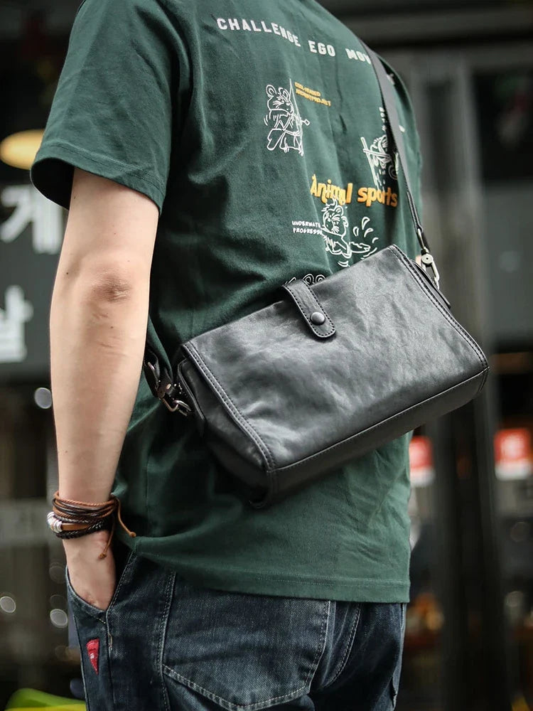 Cowhide one shoulder diagonal fashion bag in black, featuring an adjustable strap and premium leather construction for stylish and practical everyday use.