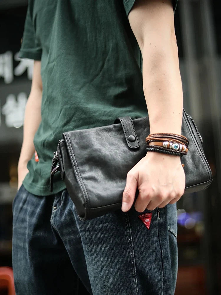 Cowhide one shoulder diagonal fashion bag in black, featuring an adjustable strap and premium leather construction for stylish and practical everyday use.