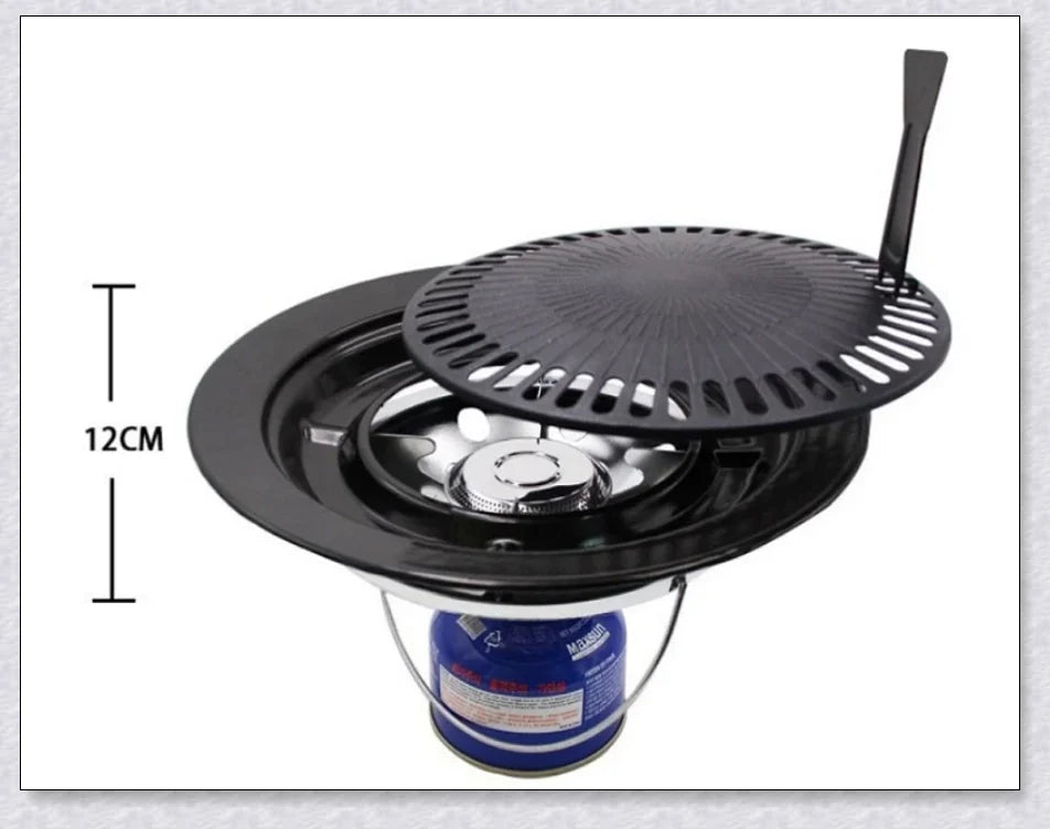 Hunters Creek Portable Korean Outdoor Barbecue Gas Grill Pan with various cooking accessories, including a baking tray, kettle, and pot