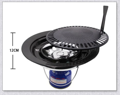 Hunters Creek Portable Korean Outdoor Barbecue Gas Grill Pan with various cooking accessories, including a baking tray, kettle, and pot