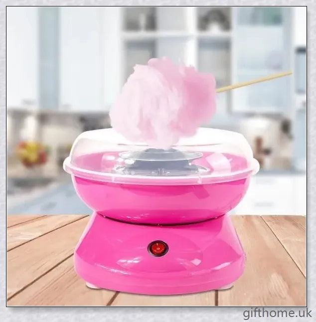 A red cotton candy maker machine on a counter, creating fluffy, cloud-like cotton candy.
