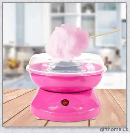 A red cotton candy maker machine on a counter, creating fluffy, cloud-like cotton candy.