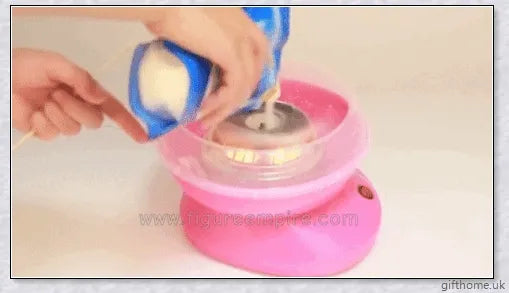 A red cotton candy maker machine on a counter, creating fluffy, cloud-like cotton candy.