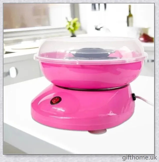 A red cotton candy maker machine on a counter, creating fluffy, cloud-like cotton candy.