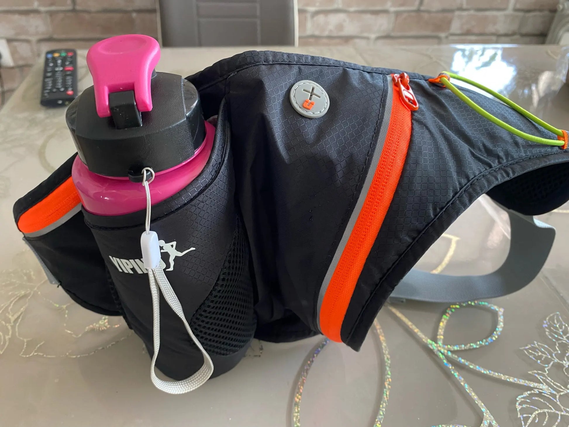 Running Water Bottle Waist Pack with adjustable strap, water bottle holder, and reflective safety features
