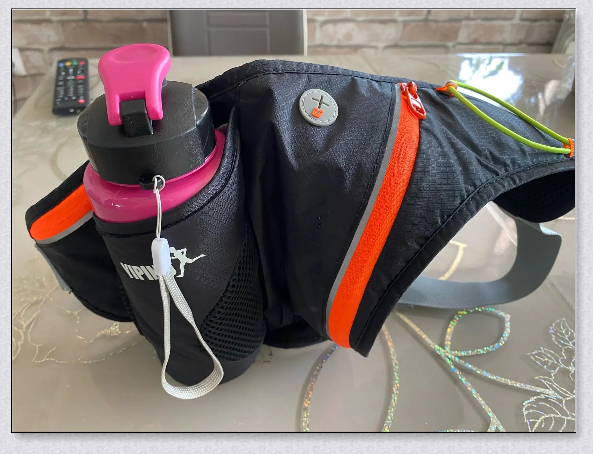 Running Water Bottle Waist Pack with adjustable strap, water bottle holder, and reflective safety features