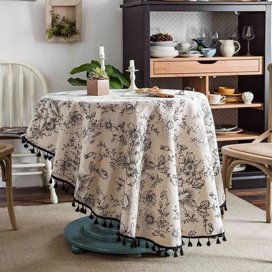 Elegant floral cotton linen round tablecloth with tassels, adding sophisticated charm to any dining setting