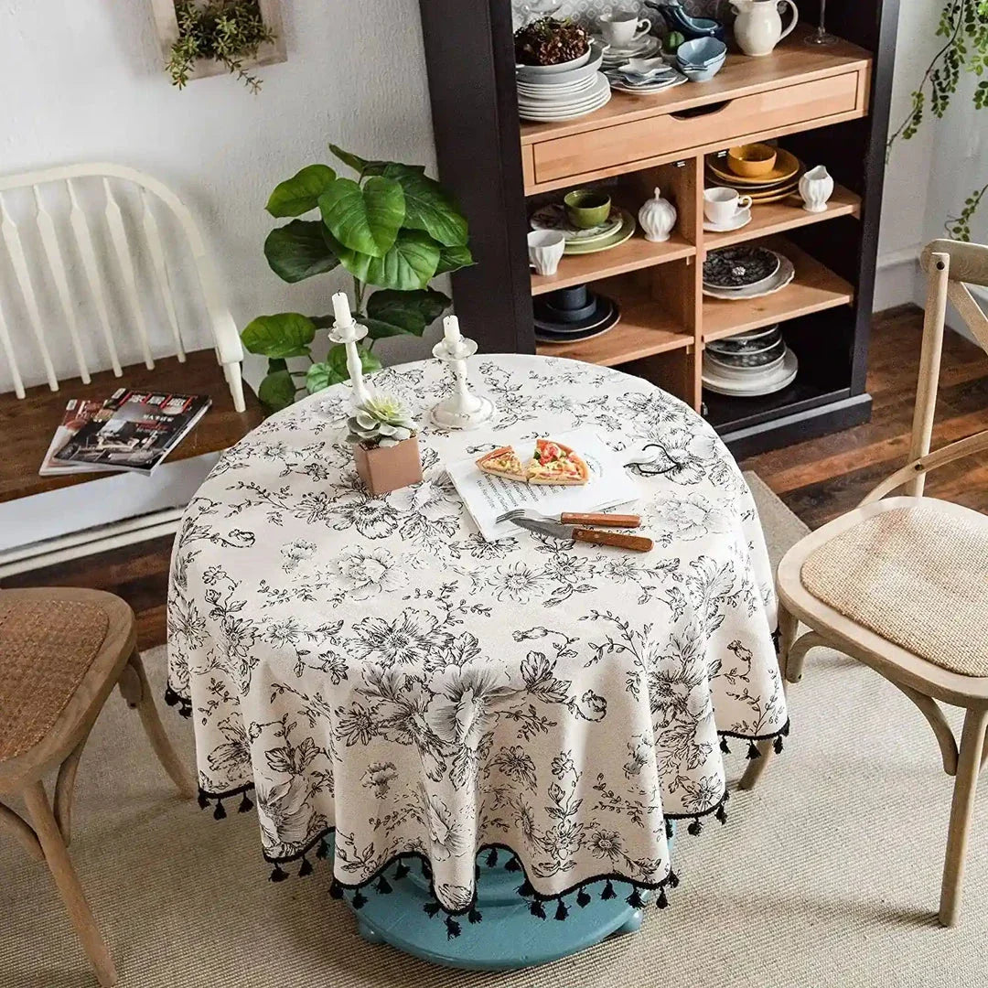 Elegant floral cotton linen round tablecloth with tassels, adding sophisticated charm to any dining setting