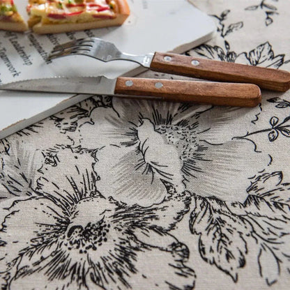 Elegant floral cotton linen round tablecloth with tassels, adding sophisticated charm to any dining setting