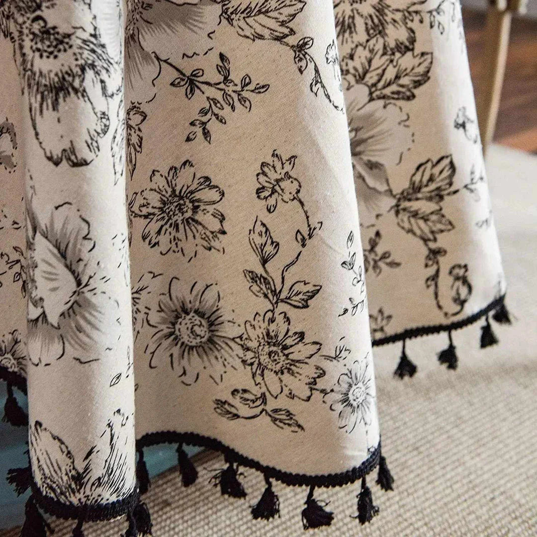 Elegant floral cotton linen round tablecloth with tassels, adding sophisticated charm to any dining setting