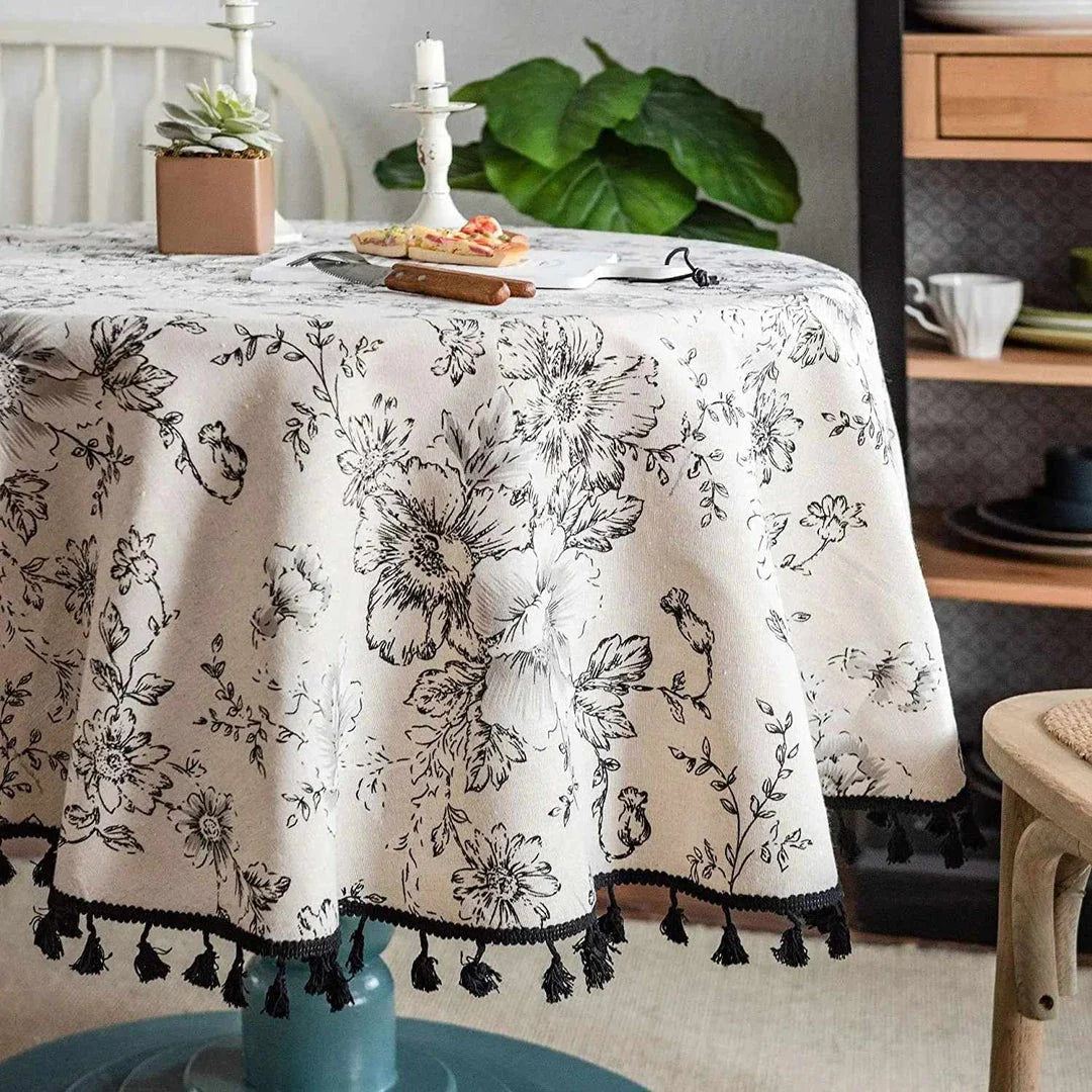 Elegant floral cotton linen round tablecloth with tassels, adding sophisticated charm to any dining setting