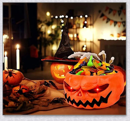 Pumpkin-shaped candy bowl with a creepy moving skeleton hand that jumps out to startle guests, ideal for Halloween decorations and parties.