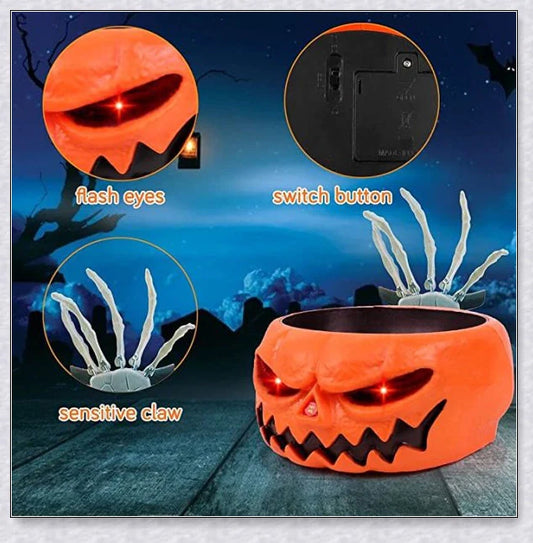 Pumpkin-shaped candy bowl with a creepy moving skeleton hand that jumps out to startle guests, ideal for Halloween decorations and parties.