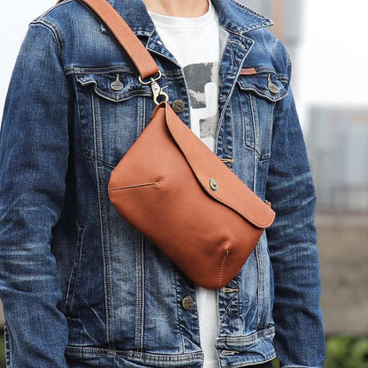A vintage-inspired brown leather messenger bag with an adjustable strap and multiple interior compartments for organisation and storage.