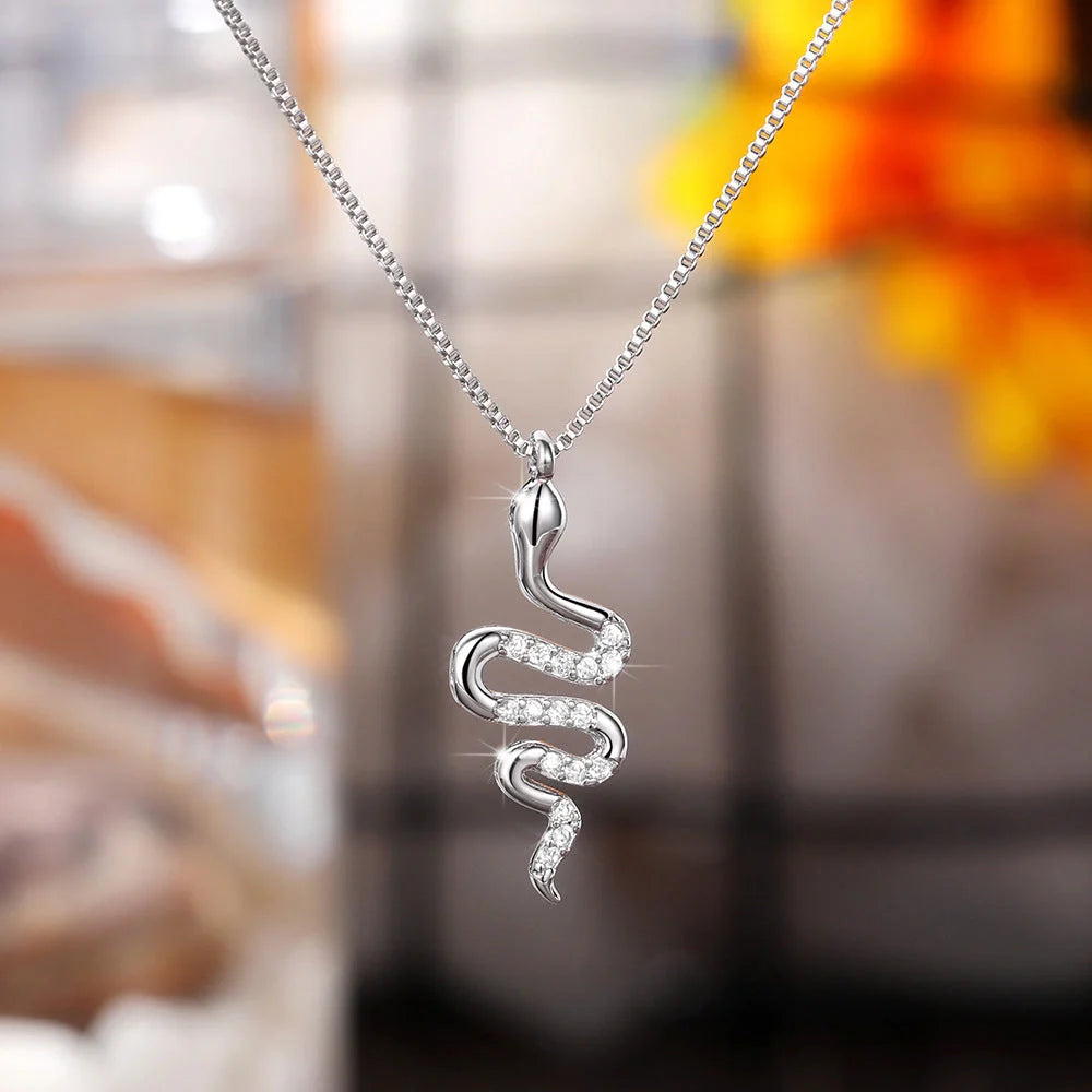 Snake pendant necklace with zirconia stones in white gold and gold finishes