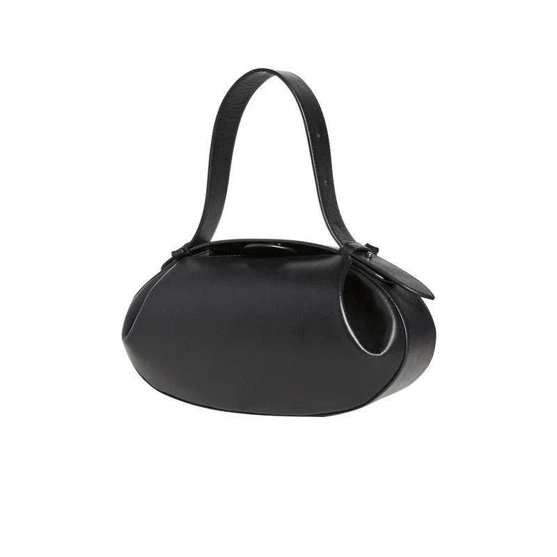 Elegant round vegan leather handbag with a distinctive circular shape, durable construction, and spacious interior organisation