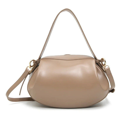 Elegant round vegan leather handbag with a distinctive circular shape, durable construction, and spacious interior organisation