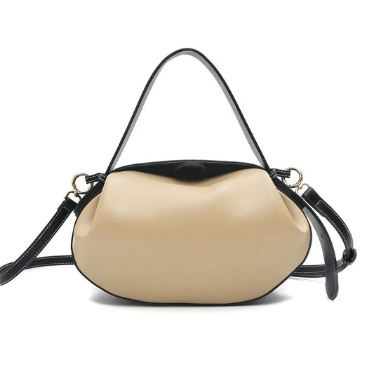 Elegant round vegan leather handbag with a distinctive circular shape, durable construction, and spacious interior organisation