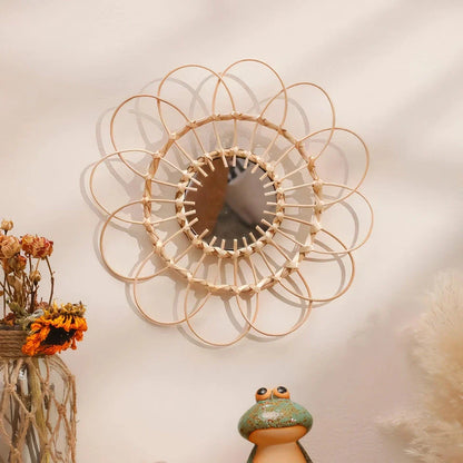 Handmade rattan decorative wall mirror with a flower-shaped design, adding natural charm and elegance to a living space.