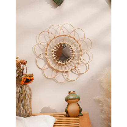 Handmade rattan decorative wall mirror with a flower-shaped design, adding natural charm and elegance to a living space.