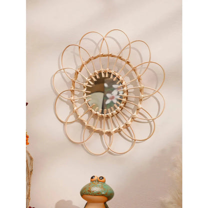 Handmade rattan decorative wall mirror with a flower-shaped design, adding natural charm and elegance to a living space.