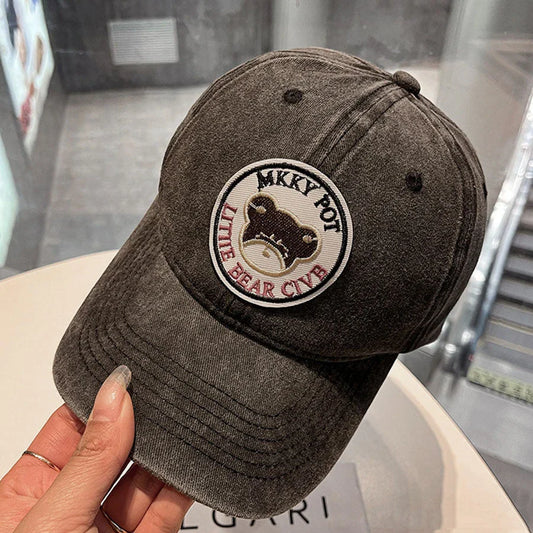 Two pink baseball caps with a cartoon love design, perfect for both women and men to add a touch of playful personality to their outfits.