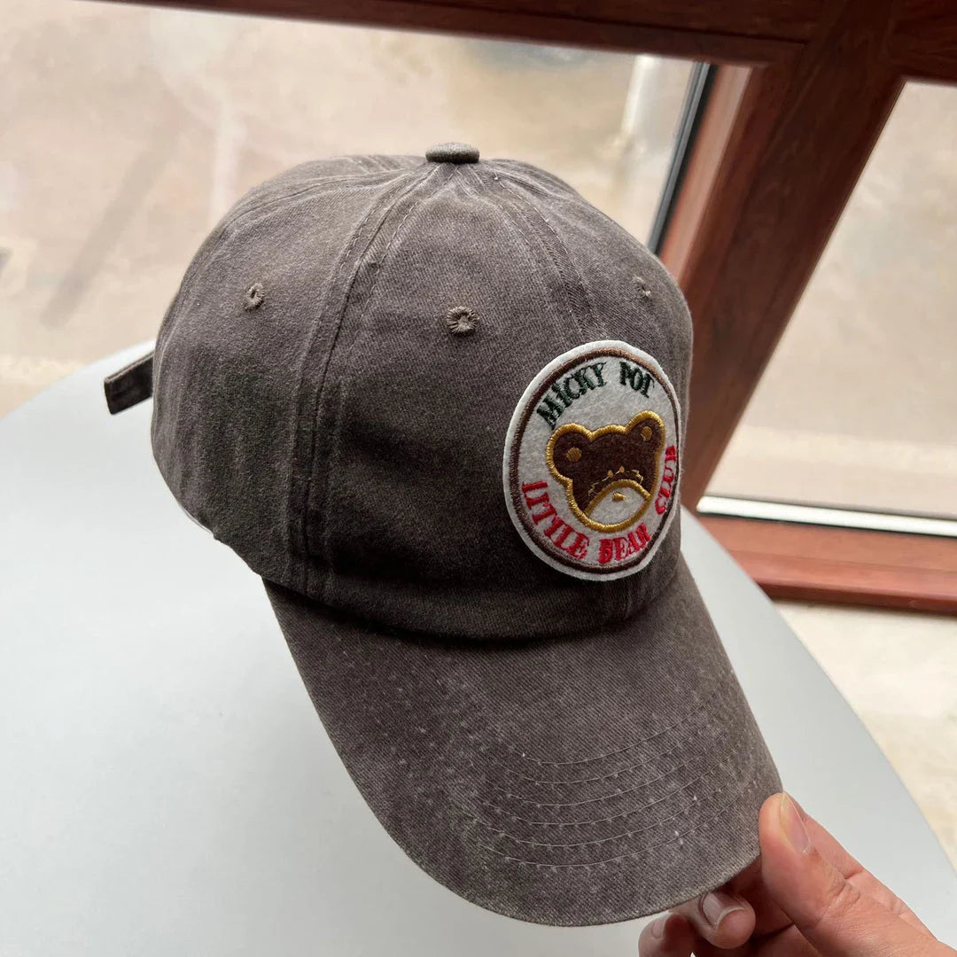 Two pink baseball caps with a cartoon love design, perfect for both women and men to add a touch of playful personality to their outfits.