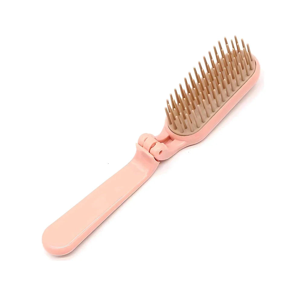 Compact, foldable hair brush with built-in scalp massager for convenient hair care on the go