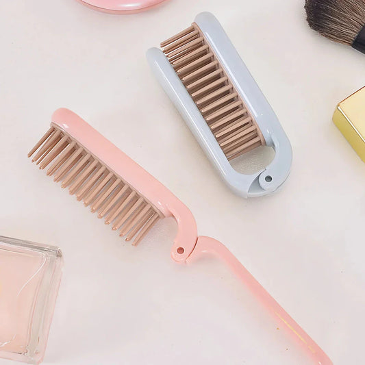 Compact, foldable hair brush with built-in scalp massager for convenient hair care on the go