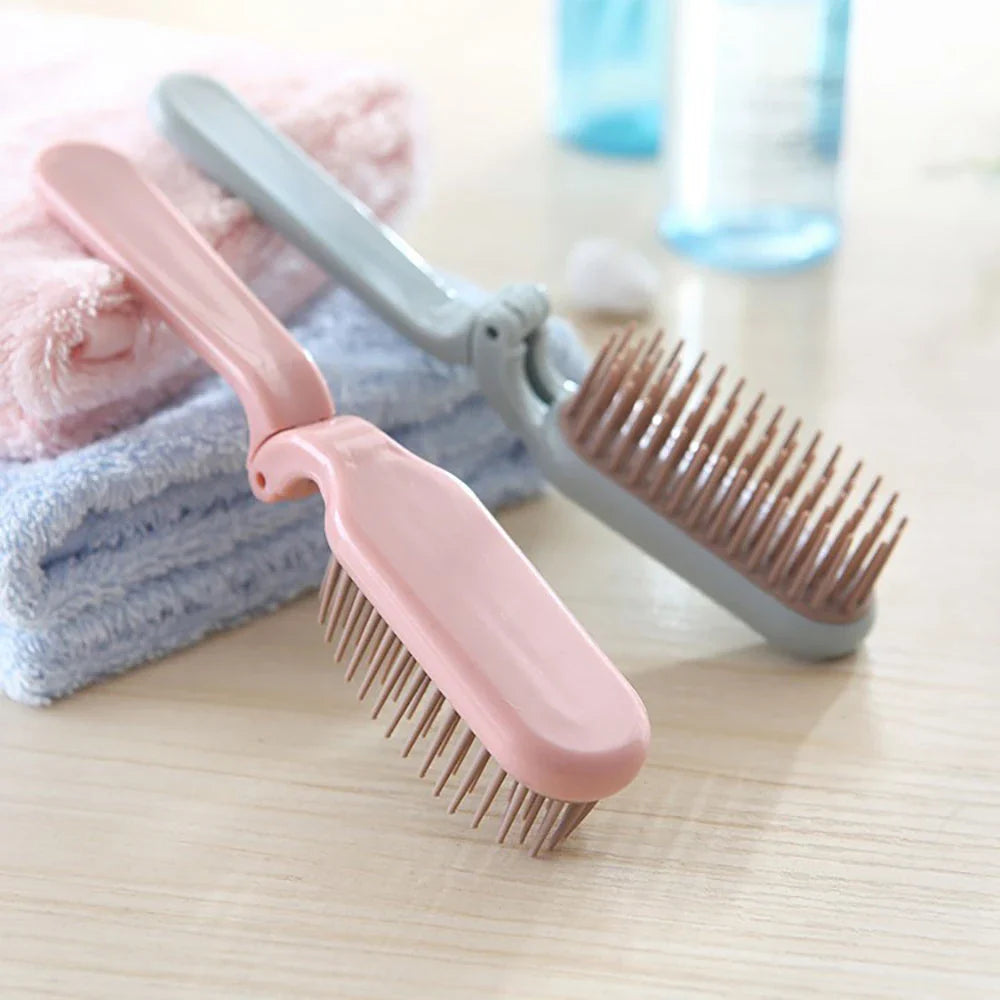 Compact, foldable hair brush with built-in scalp massager for convenient hair care on the go