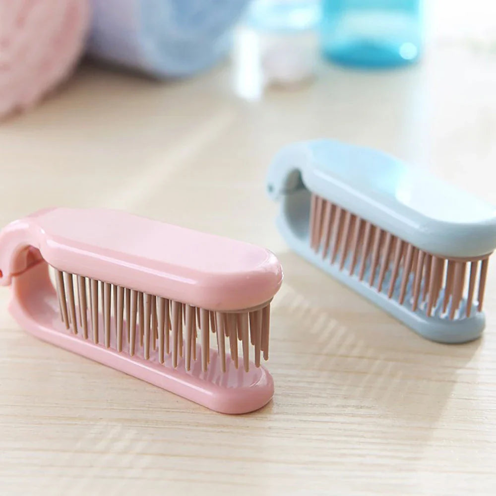 Compact, foldable hair brush with built-in scalp massager for convenient hair care on the go