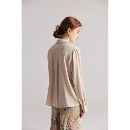 Elegant ruffled v-neck silk blouse in a champagne colour, featuring a straight and regular fit design for a timeless look.