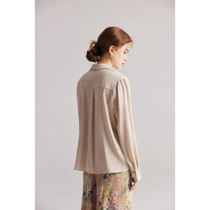 Elegant ruffled v-neck silk blouse in a champagne colour, featuring a straight and regular fit design for a timeless look.