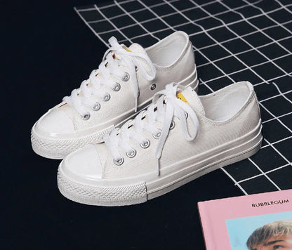 Pair of colour-changing canvas shoes with a white upper and a flat, rubber sole