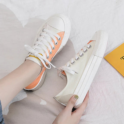Pair of colour-changing canvas shoes with a white upper and a flat, rubber sole
