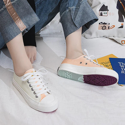 Pair of colour-changing canvas shoes with a white upper and a flat, rubber sole