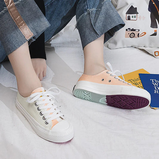 Pair of colour-changing canvas shoes with a white upper and a flat, rubber sole