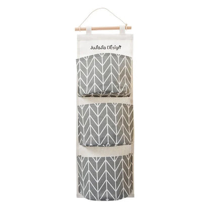 A green hanging storage bag with three compartments, designed to neatly organise everyday items in the home.