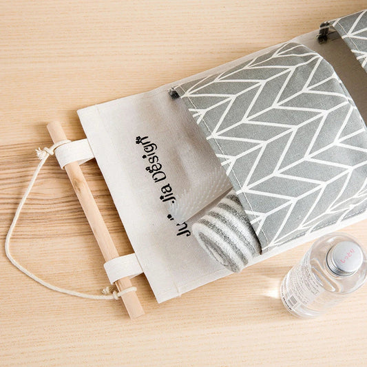 A green hanging storage bag with three compartments, designed to neatly organise everyday items in the home.