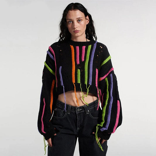 A chic knitted pullover with tassels and a patchwork design, perfect for autumn and winter fashion.