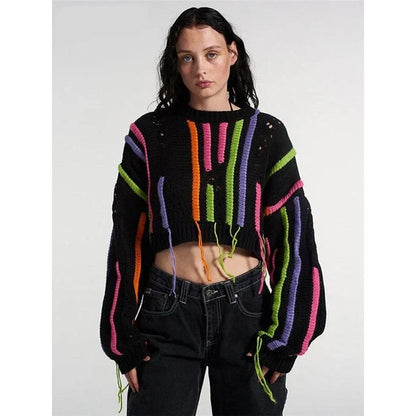 A chic knitted pullover with tassels and a patchwork design, perfect for autumn and winter fashion.