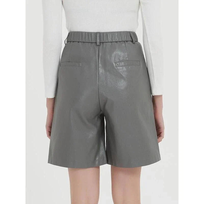 Elegant knee-length PU leather shorts for women in gray, featuring a regular fit design with a mid-rise waist and elastic waistband for maximum comfort and style.